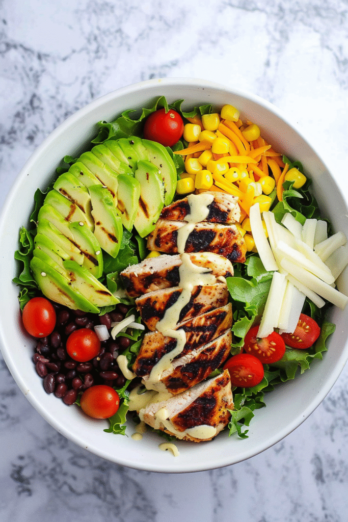 High Protein Southwest Chicken Salad (Macro-Friendly & Meal Prep Ready!) 2 Southwest chicken salad with grilled chicken, avocado, black beans, corn, and creamy dressing on gray marble
